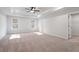 Spacious bedroom with neutral carpet, a ceiling fan, and plenty of natural light from two windows at 686 Smokey Quartz Way, Kennesaw, GA 30144