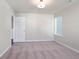 The bedroom features neutral walls, carpet floors, a window, and a white door at 686 Smokey Quartz Way, Kennesaw, GA 30144