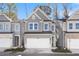 Charming two-story townhome featuring a gray facade, well-manicured lawn, and an attached two-car garage at 686 Smokey Quartz Way, Kennesaw, GA 30144