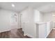Bright hallway features wood floors, white walls, and access to other rooms in this modern home at 686 Smokey Quartz Way, Kennesaw, GA 30144