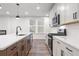 Well-designed kitchen with white countertops, stainless steel appliances, and contrasting brown cabinets at 686 Smokey Quartz Way, Kennesaw, GA 30144