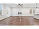 Open-concept living area with a fireplace, multiple windows, and stylish lighting fixtures, creating a cozy space at 686 Smokey Quartz Way, Kennesaw, GA 30144