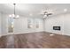 Bright living room with a fireplace, modern light fixture, and a glass door leading to outdoor space at 686 Smokey Quartz Way, Kennesaw, GA 30144