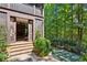 Outdoor patio with brick steps leading to a screened porch and backyard with custom putting green at 1762 Nancy Creek Bluff, Atlanta, GA 30305