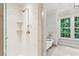 Modern bathroom with a glass-enclosed shower and separate soaking tub near a large window at 1762 Nancy Creek Bluff, Atlanta, GA 30305