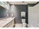 Well-lit bathroom featuring a marble countertop, modern fixtures, and decorative shower curtain at 1762 Nancy Creek Bluff, Atlanta, GA 30305