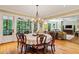 Bright dining room with hardwood floors and adjacent screened porch access at 1762 Nancy Creek Bluff, Atlanta, GA 30305