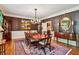 Formal dining room with striped walls, elegant chandelier, and hardwood flooring at 1762 Nancy Creek Bluff, Atlanta, GA 30305