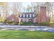 Charming brick home with manicured lawn, fenced entrance, dormer windows, and a prominent chimney at 1762 Nancy Creek Bluff, Atlanta, GA 30305