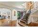 Grand foyer with staircase, hardwood floors, and elegant decorative railing at 1762 Nancy Creek Bluff, Atlanta, GA 30305