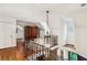 Open hallway with hardwood floors, leading to a bedroom, with an iron railing feature at 1762 Nancy Creek Bluff, Atlanta, GA 30305