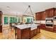 Spacious kitchen with a marble island, farmhouse sink, custom cabinets, and lots of natural light at 1762 Nancy Creek Bluff, Atlanta, GA 30305