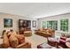 Bright living room with large windows, neutral carpet, and comfortable furnishings at 1762 Nancy Creek Bluff, Atlanta, GA 30305
