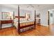 Primary suite with a four-poster bed, hardwood floors, and elegant decor at 1762 Nancy Creek Bluff, Atlanta, GA 30305