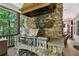Stone outdoor grill with a stainless steel grill and wooden overhead hood at 1762 Nancy Creek Bluff, Atlanta, GA 30305