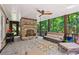 Inviting outdoor patio with stone fireplace, comfortable seating, and serene wooded views at 1762 Nancy Creek Bluff, Atlanta, GA 30305