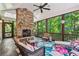 Inviting screened porch with a stone fireplace and comfortable seating, perfect for relaxing at 1762 Nancy Creek Bluff, Atlanta, GA 30305