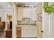 Convenient wet bar with custom cabinets, granite countertop, and a stainless steel refrigerator at 1762 Nancy Creek Bluff, Atlanta, GA 30305