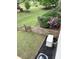 The backyard features a wooden fence, green grass, flower bushes and an air conditioner at 416 Telfair Way, Canton, GA 30115