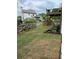 The backyard features a wooden fence, lush green grass, and a wooden deck with stairs at 416 Telfair Way, Canton, GA 30115