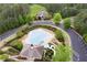 Aerial view of the community pool area with a clubhouse, surrounded by well-manicured landscaping at 416 Telfair Way, Canton, GA 30115