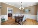 Formal dining room with wainscoting, chandelier, and hardwood floors at 416 Telfair Way, Canton, GA 30115