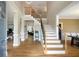 Inviting foyer with hardwood floors, a staircase with iron balusters, and views into other living spaces at 416 Telfair Way, Canton, GA 30115