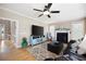 Inviting living room with hardwood floors, a fireplace, and a comfortable seating area at 416 Telfair Way, Canton, GA 30115