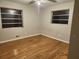 Bedroom with hardwood floors, neutral walls, and bright natural light shining in from two windows at 5535 Beaver Sw Dr, Mableton, GA 30126