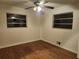 Empty bedroom featuring hardwood floors and natural light from two windows at 5535 Beaver Sw Dr, Mableton, GA 30126