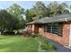Charming brick home featuring mature landscaping and a walkway leading to the front entrance at 5535 Beaver Sw Dr, Mableton, GA 30126