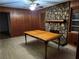Living room with stone fireplace, ceiling fan, and wood paneled walls at 5535 Beaver Sw Dr, Mableton, GA 30126