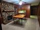 Cozy living room showcases a stone fireplace and wood-paneled walls at 5535 Beaver Sw Dr, Mableton, GA 30126