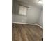 This bedroom features hardwood flooring and a window for natural lighting at 5690 Deerfield Ct, College Park, GA 30349
