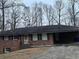 Cozy brick home featuring an attached carport and a well-maintained front lawn at 5690 Deerfield Ct, College Park, GA 30349