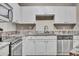 Bright kitchen featuring stainless steel appliances, white cabinets, and granite countertops at 1850 Cotillion Dr # 3305, Atlanta, GA 30338