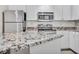 Beautiful kitchen island with granite countertops, paired with stainless steel appliances and white cabinets at 1850 Cotillion Dr # 3305, Atlanta, GA 30338