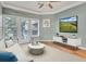 Cozy living room with neutral tones, balcony access, and a modern entertainment setup at 1850 Cotillion Dr # 3305, Atlanta, GA 30338