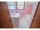 Retro pink bathroom with white sink, hexagon tile floor, toilet and bathtub at 2283 Country Club Sw Ln, Atlanta, GA 30311