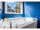 Close up of bathtub with a faucet and handle and a window that lets in ample natural light at 5815 Buckner Creek Dr, Mableton, GA 30126