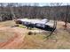 Aerial view of a home showcasing its sprawling lot, white roof, and surrounding mature trees at 1370 Cronic Town Rd, Auburn, GA 30011