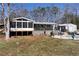 Back of house with screened in porch, fenced in pool and lots of backyard space at 1370 Cronic Town Rd, Auburn, GA 30011