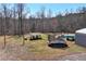 Expansive backyard featuring a swing set, trampoline, and a fenced pool area for outdoor enjoyment at 1370 Cronic Town Rd, Auburn, GA 30011