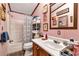 This bathroom features a mirror with cabinet, sink, toilet, and shower at 1370 Cronic Town Rd, Auburn, GA 30011