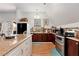 Charming kitchen featuring dark wood cabinets, a modern stove, and ample counter space at 1370 Cronic Town Rd, Auburn, GA 30011