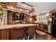 Charming kitchen with wood cabinets, stainless steel appliances and breakfast bar with wicker stools at 1370 Cronic Town Rd, Auburn, GA 30011