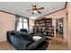 Inviting living room with a plush sofa, built-in bookshelves, and neutral wall color at 1370 Cronic Town Rd, Auburn, GA 30011