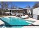 Sparkling fenced in pool with diving board and hot tub and seating area at 1370 Cronic Town Rd, Auburn, GA 30011