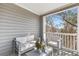 Relax on this cozy covered balcony, complete with seating and views of the surrounding trees at 2700 Pine Tree Ne Rd # 2201, Atlanta, GA 30324