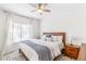 Bright bedroom featuring a ceiling fan, large window, and a comfortable queen-size bed with stylish decor at 2700 Pine Tree Ne Rd # 2201, Atlanta, GA 30324